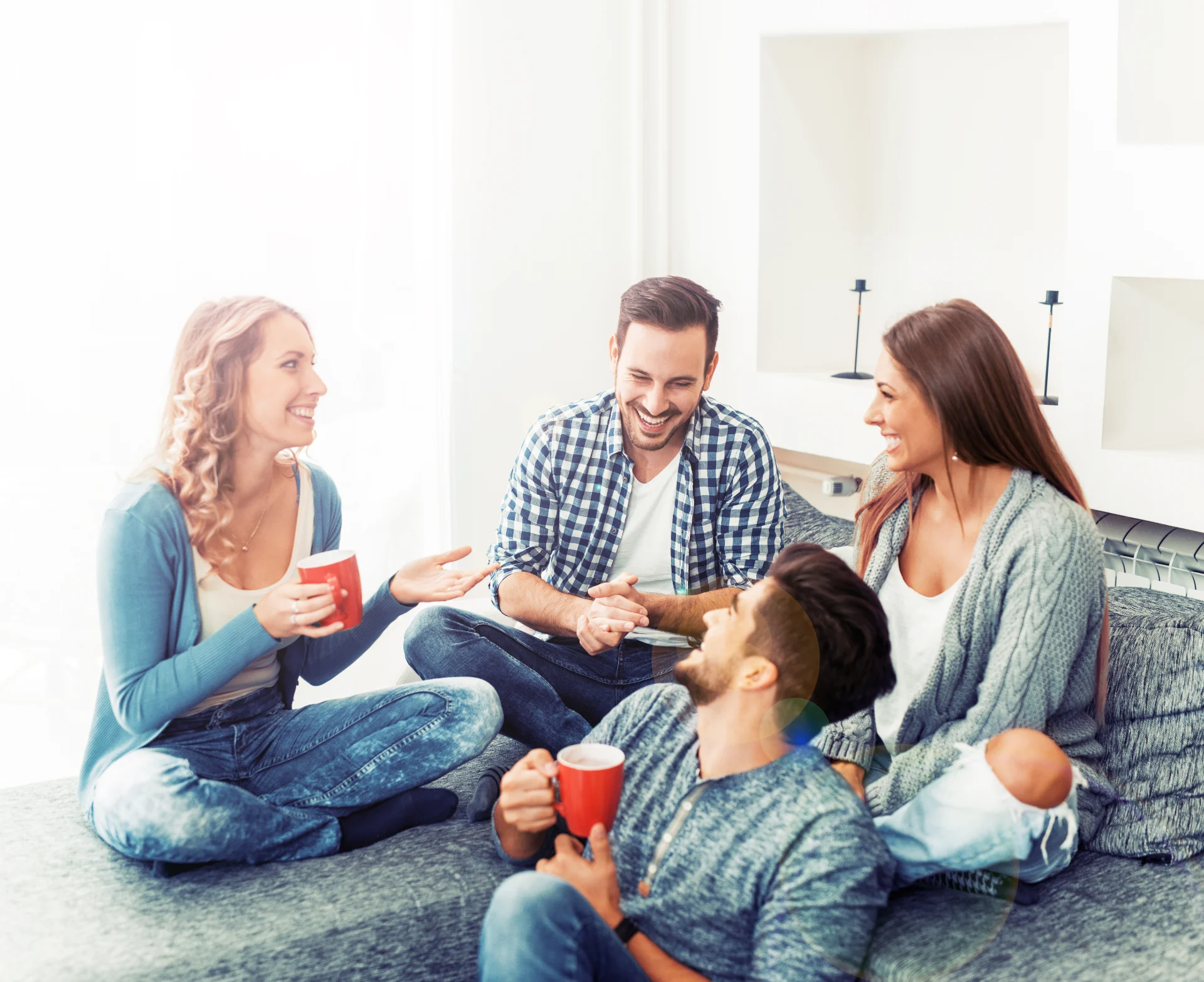 Group of friends talking on a couch Group of friends talking and having fun while sitting on the couch. They are meeting at friend's home for a coffee break.